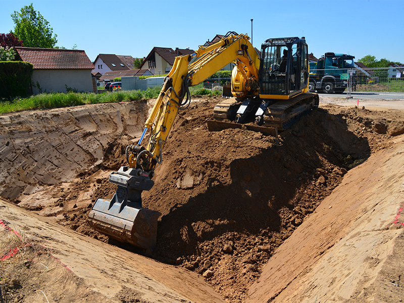 Bagger hebt Baugrube im Neubaugebiet aus, professionelle Erdarbeiten in Ratzeburg sichern stabile Fundamente und nachhaltige Bauprojekte.